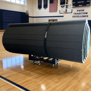 EZ Flex mat transport dolly carrying a rolled wrestling mat in a gymnasium